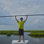 Young boy poses during a fishing trip