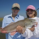 Two women are delighted after catching a redfish