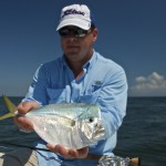Man in light blue shirt with the fish he caught