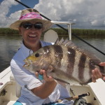 Man in white outfit with the redfish and bait