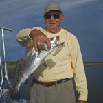 Senior man displays the fish he caught