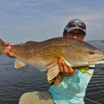 Man shows off the redfish he just caught