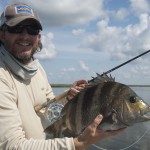 Man happily posing with the fish he just caught