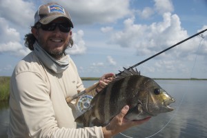 Man happily posing with the fish he just caught