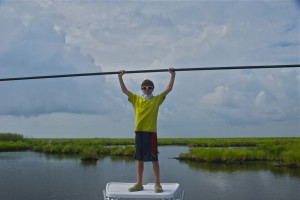 Young boy poses during a fishing trip