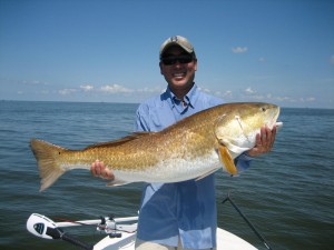 Man is very happy posing with the fish he caught