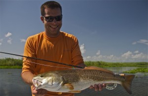 Man in orange T shirt happy with his catch