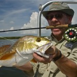 Man has a victorious look after catching a fish