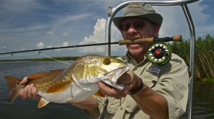 Man has a victorious look after catching a fish