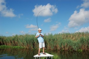 Young boy in action during a fishing trip