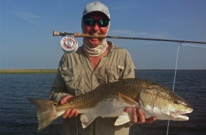 Man poses with the fish he caught