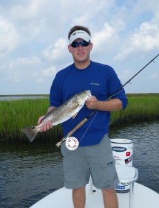 Man in dark blue T Shirt showing the fish he just caught