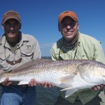 Two men celebrating a fresh catch