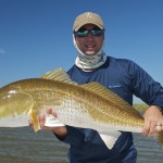 Man proudly displaying the fish he has just caught