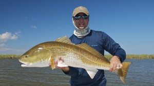 Man proudly displaying the fish he has just caught