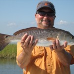 Man delightfully posing with his catch