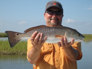 Man delightfully posing with his catch