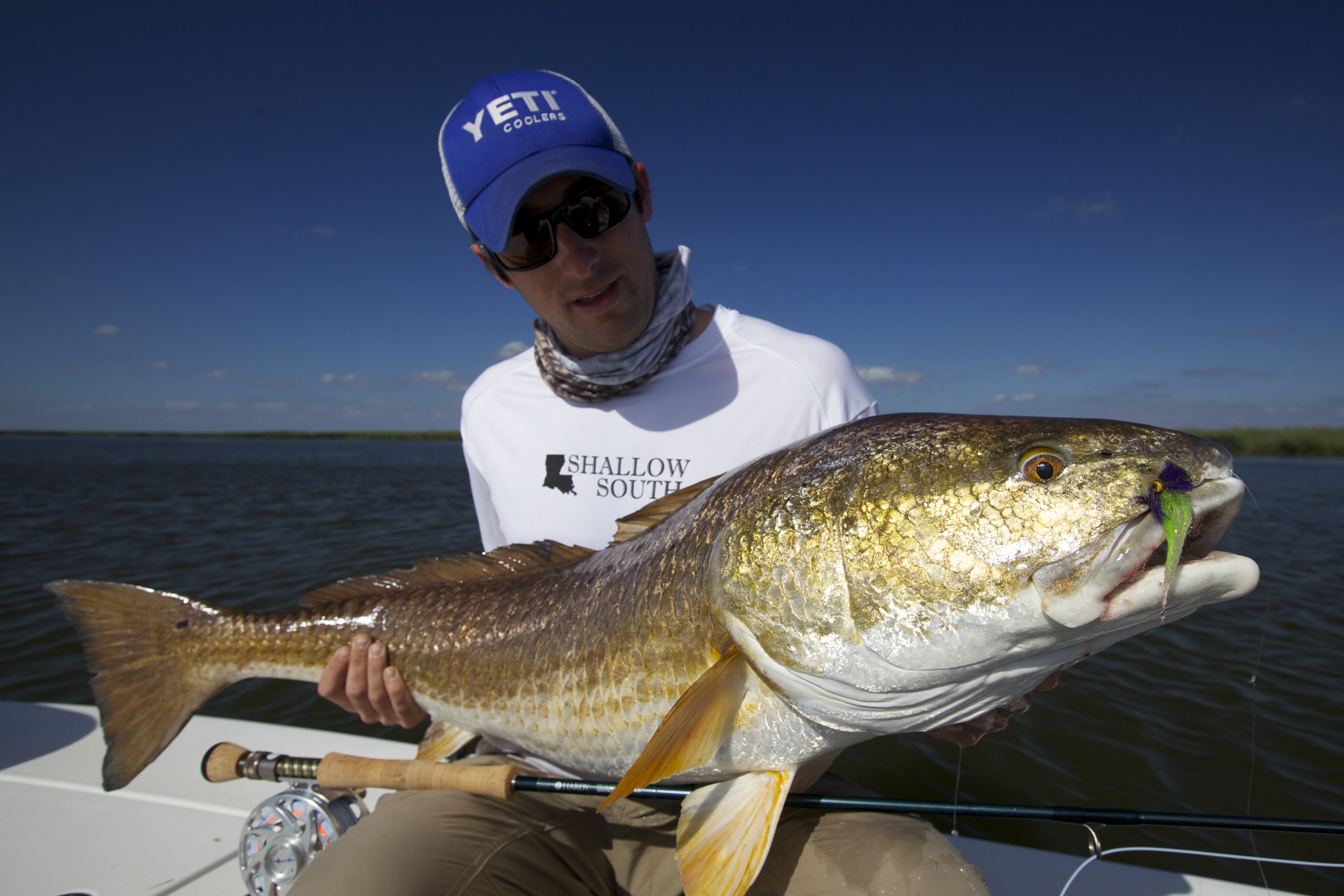 Man looks admiringly at the fish he has caught