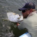 Man hauling up a fresh catch from the water