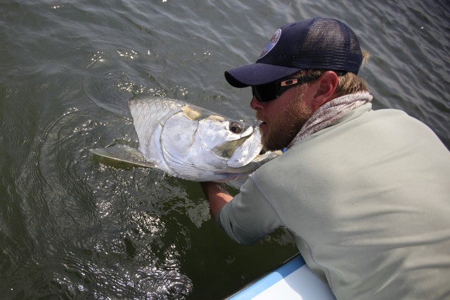 Man hauling up a fresh catch from the water