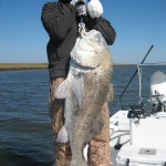 Man tries to haul up the huge fish he has caught