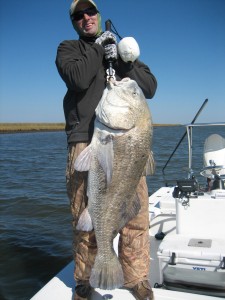 Man tries to haul up the huge fish he has caught