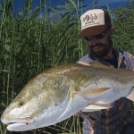 Man proudly looks at the fish he just caught