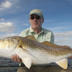 Man holds on to the fish he just caught