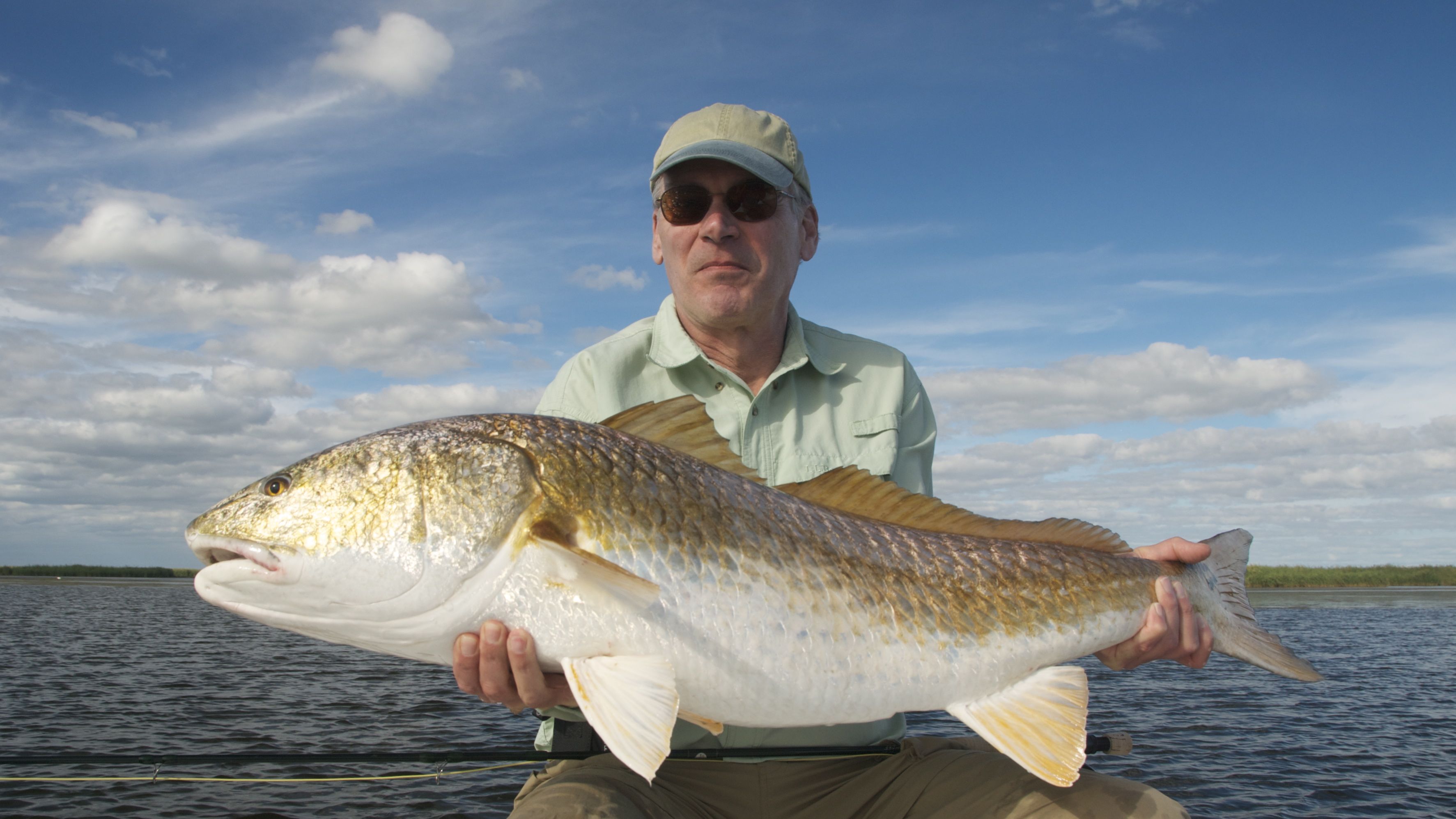 Man holds on to the fish he just caught