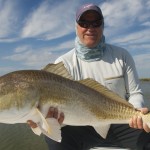 Man delightfully posing with the large fish he caught