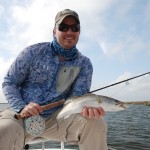 Man is check shirt is happy at his fishing success