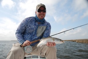 Man is check shirt is happy at his fishing success