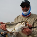 Bearded man proudly displaying his catch for the camera