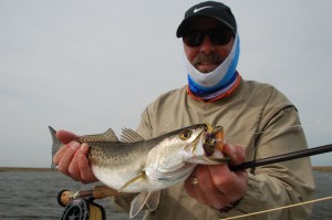 Bearded man proudly displaying his catch for the camera