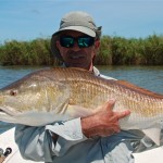 Man happily poses with the large fish he caught