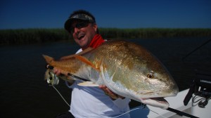 Man has a wide smile as he poses with his fish