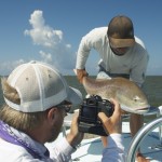 Man clicking partner with the fish he caught