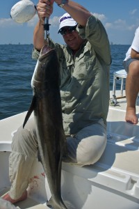 Man displays his fresh catch happily