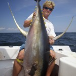 Man displays his large fresh catch happily