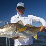 Man posing with the large fish he has just caught