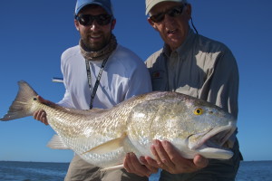 Two men are happy with the fish they just caught