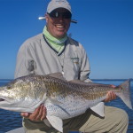 Man delights posing with his freshly caught fish