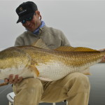 Man is admiring the fish he has just caught