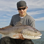 Man is admiring the large fish he just caught