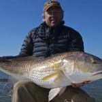 Man proudly showing the fish he just caught