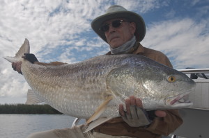 The man feels proud as he poses with the fish he caught