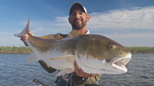 Man happily poses with the fish he caught