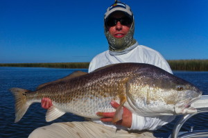 Man with light blue cap with the fish he caught