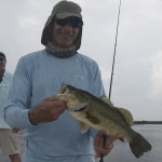 Man smiles happily after catching a fish