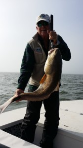 A man displays his fresh catch for the cameras